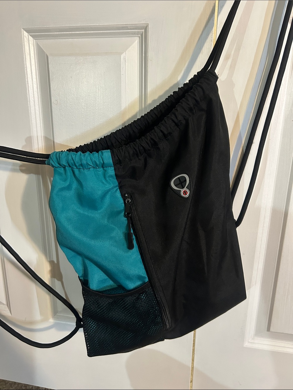 Black and Teal Drawstring Backpack with Front Pocket